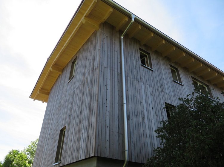 Ein Haus mit einer Grizawood Holzfassade aus Thermotanne